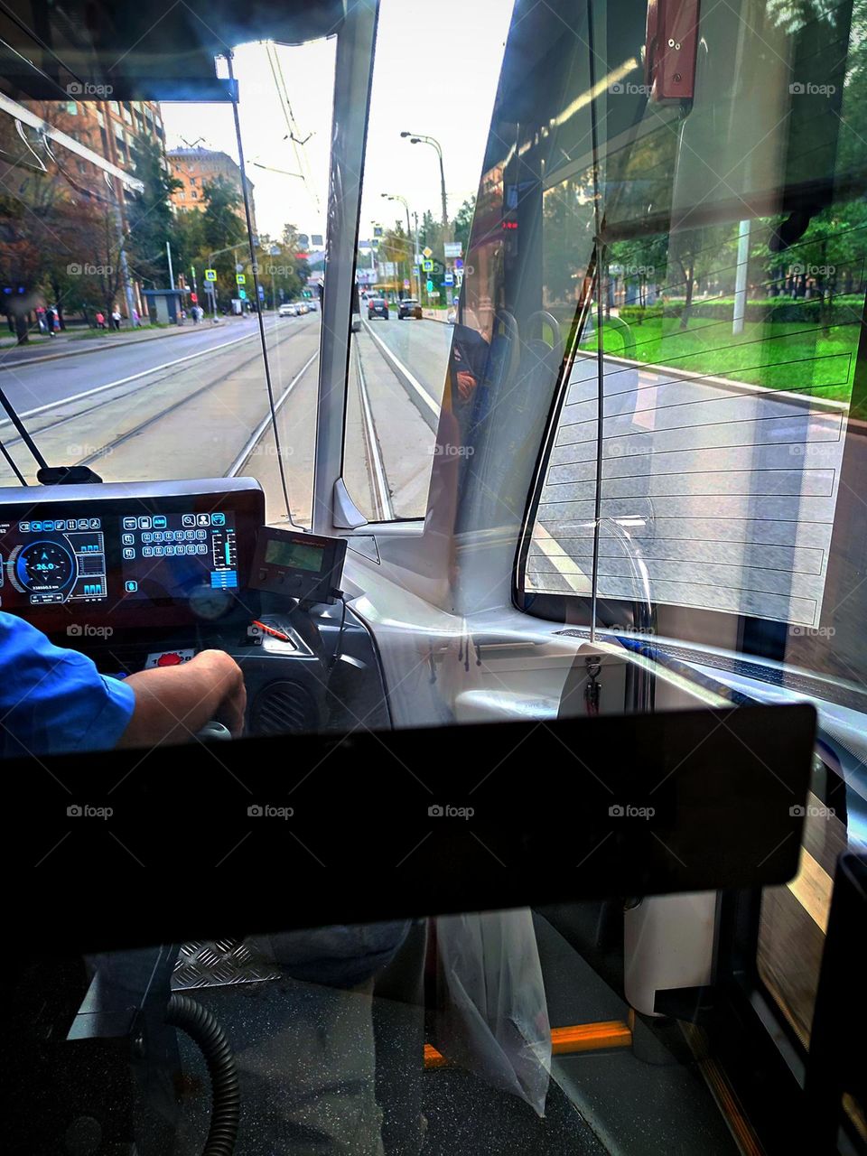 Tram cab.  View of the rails and the road from the windshield of the tram