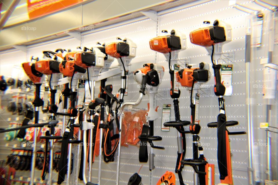Weed Wackers Hanging on Wall at Hardware Store