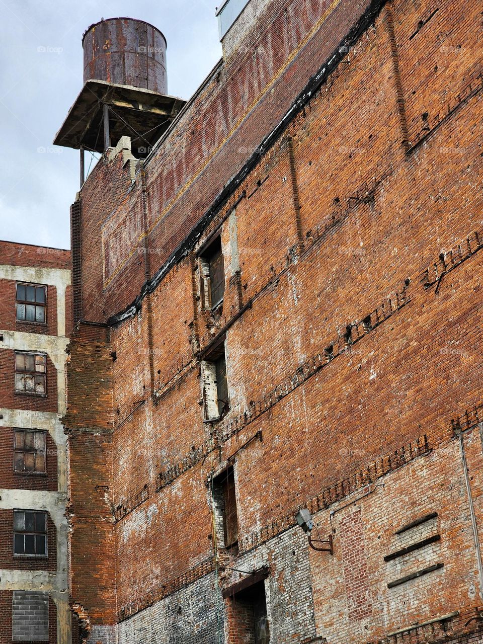 Missing its former elevator shaft, a building appears sad and deserted with exposed doorways and disintegrating parts