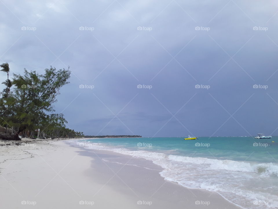 purple sky azure ocean corral beach yellow boat