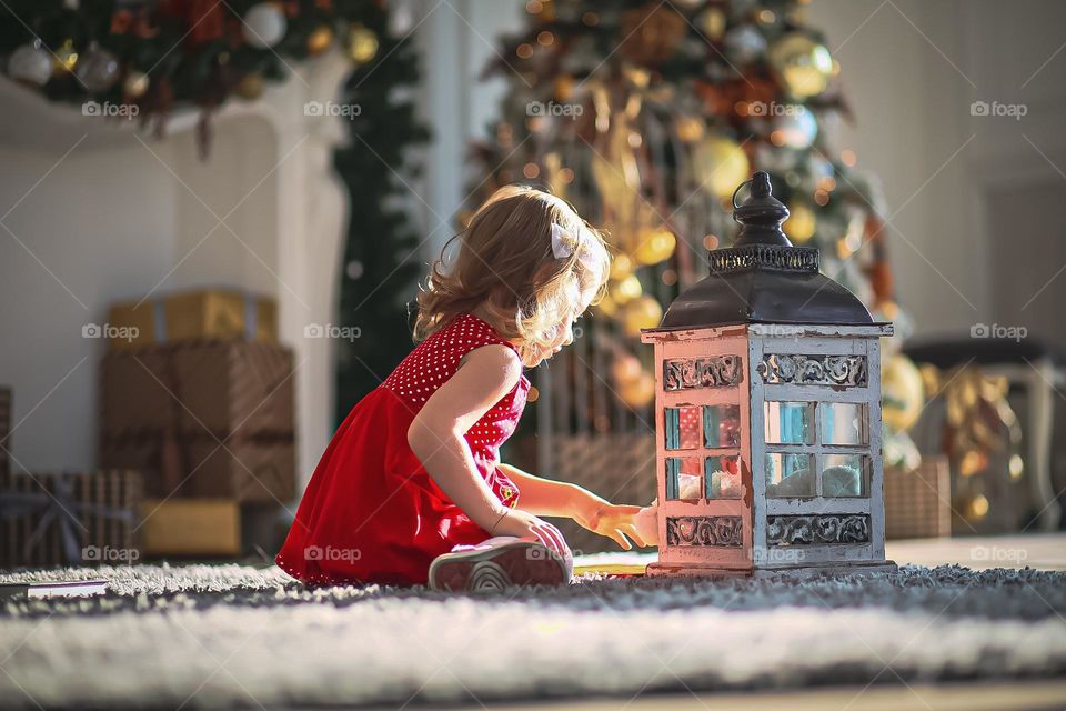 Little girl playing with a lantern