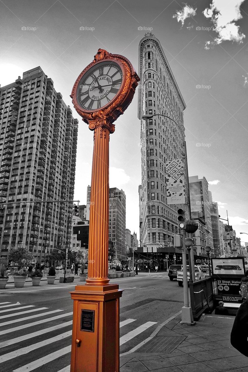 Golden clock in front of the Flatiron building