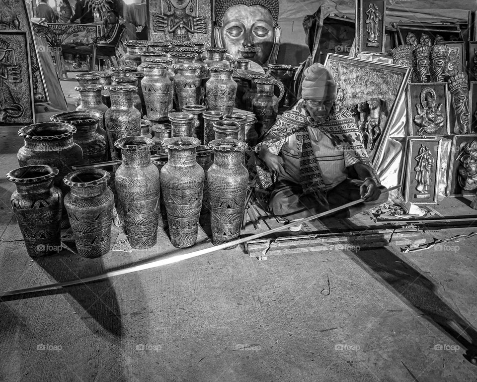 A handicraft artist busy in work.