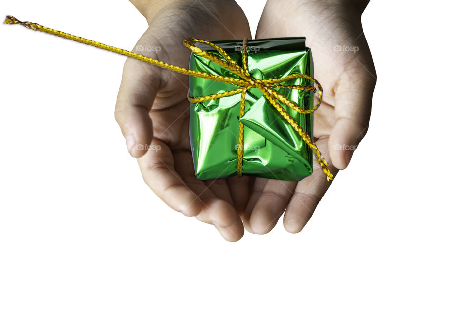 Isolated Hand holding Gift box green for the festivities on a white background.