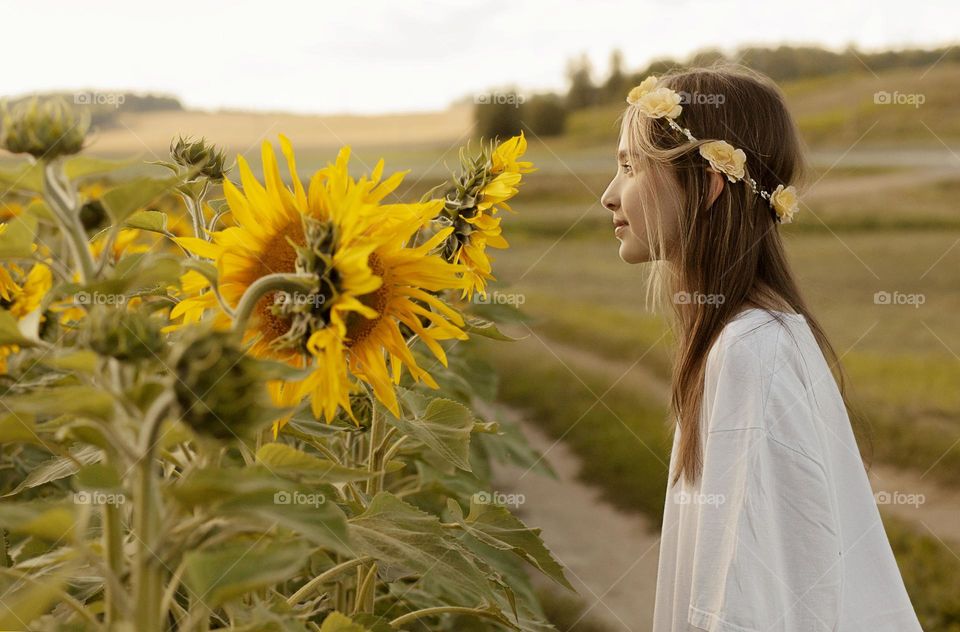 Girl and field of sunflowers, summer.