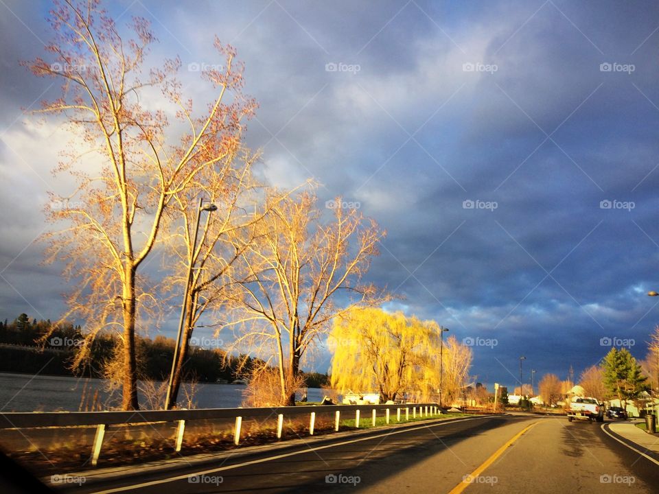 Sunrise reflections trough cloudy sky
