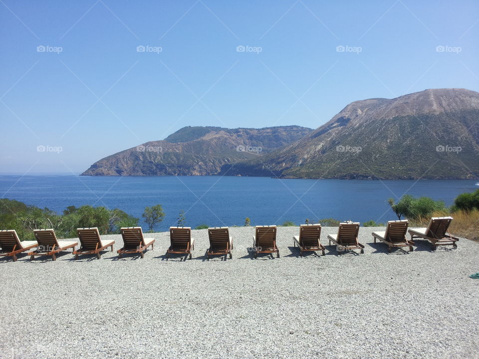 vulcano from chairs. deck chairs on a beach of volcano