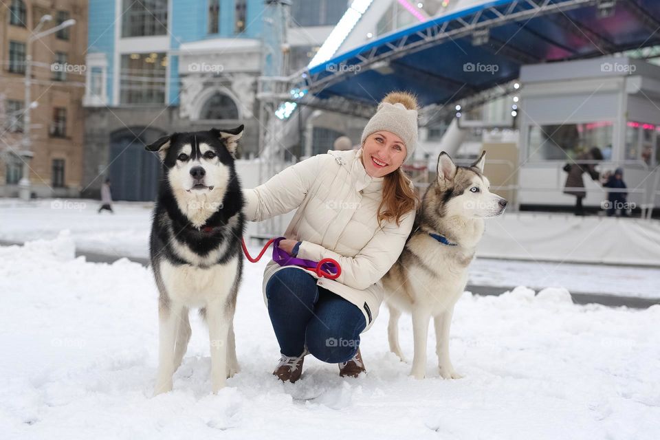 walking the dog down the street, the owner walks the weakling, teaches her, cleans up after her, educates, plays with his pet. people and dogs are best friends