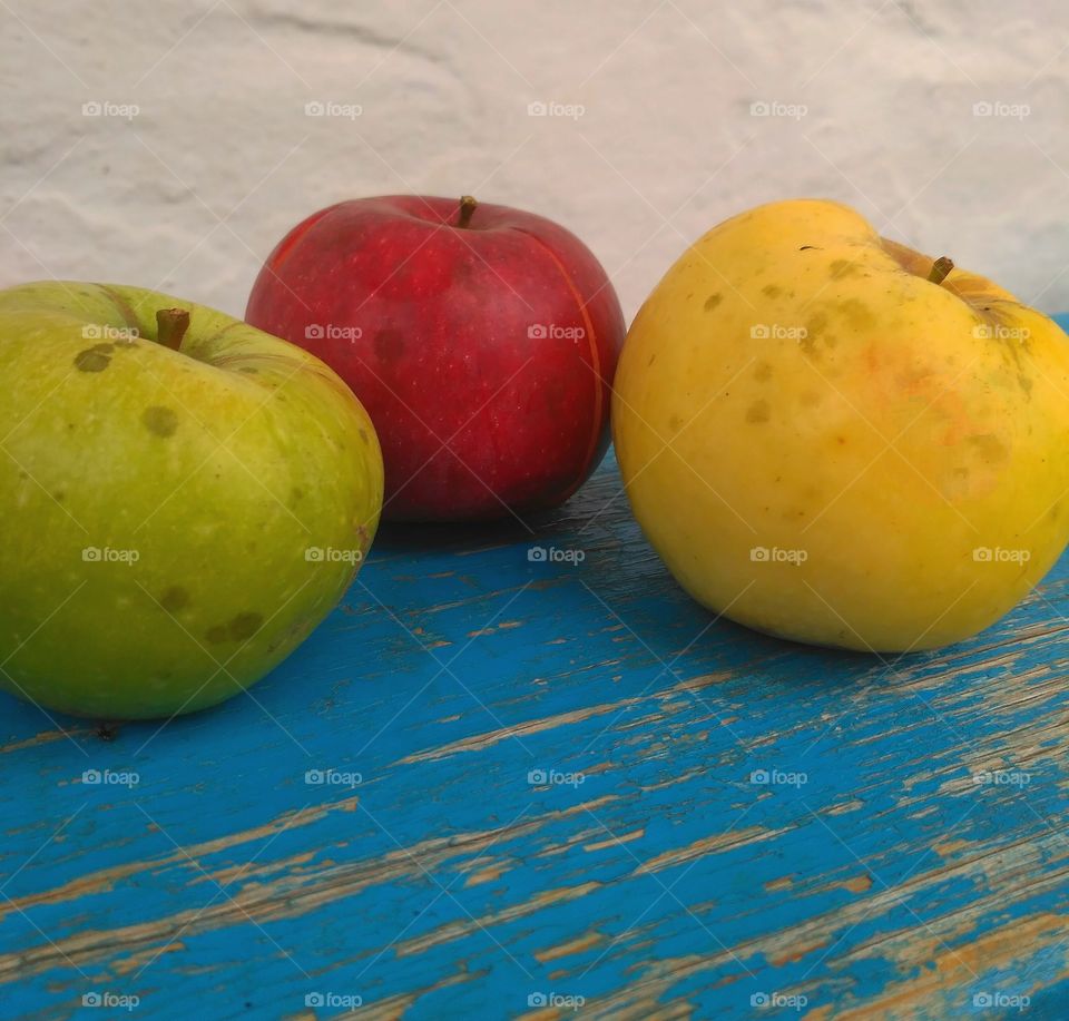 three apples on the bench