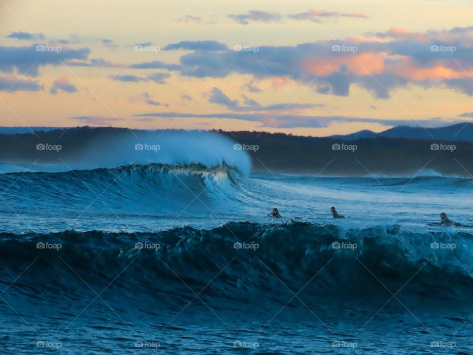 Waves crashing at sunset 