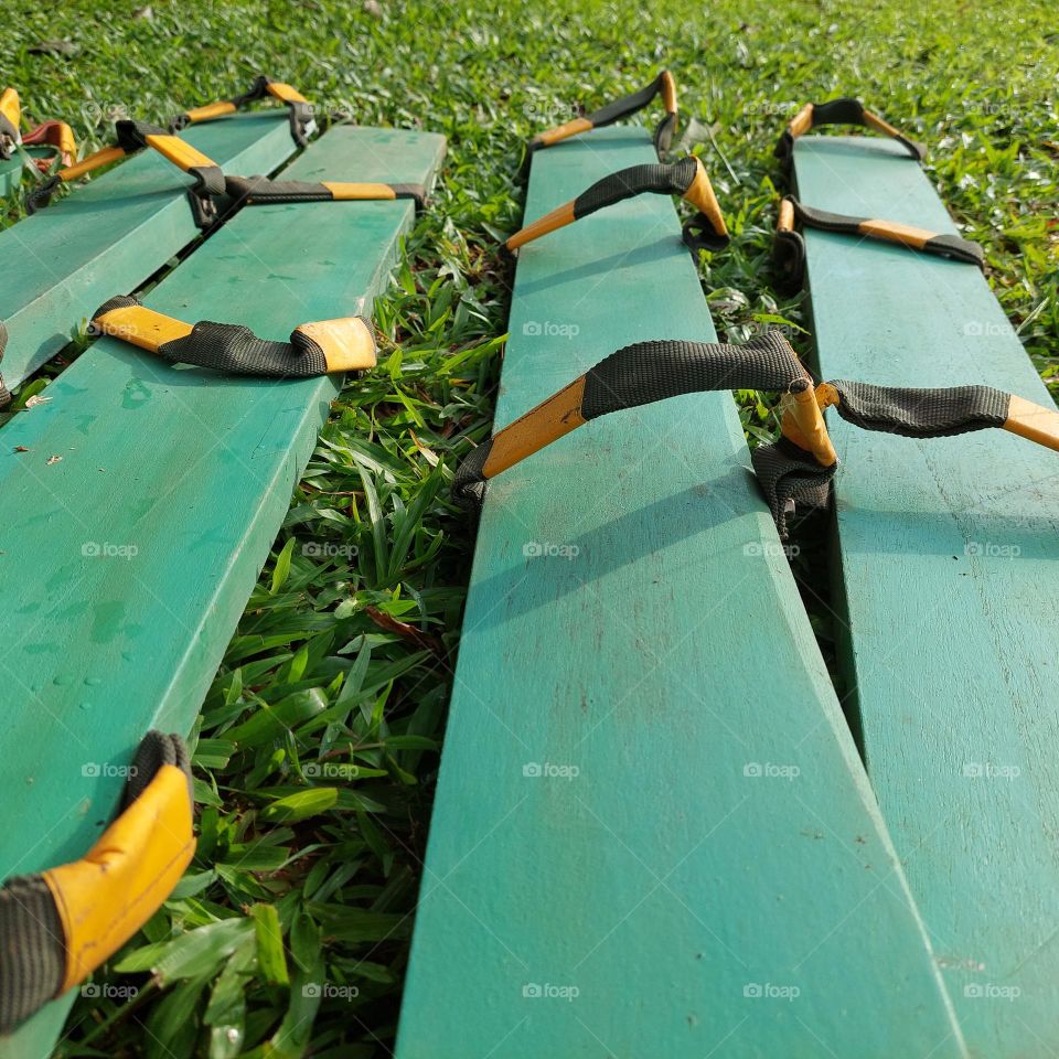 a traditional game tool from Indonesia "clogs" made of long wooden boards and rubber straps that rely on team cohesiveness