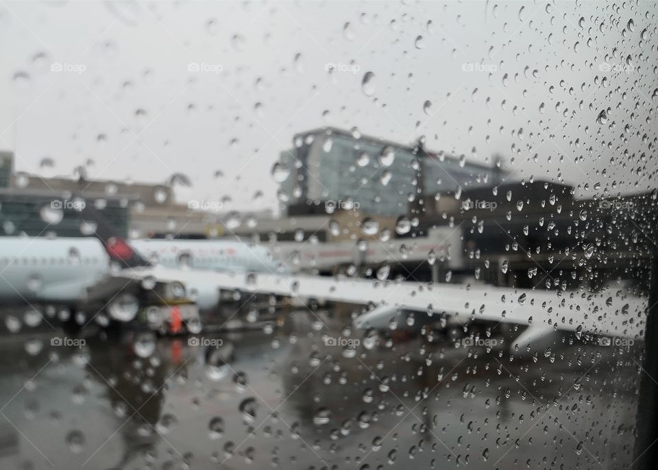 Rain on the glass off a airbus A320 Calgary airport