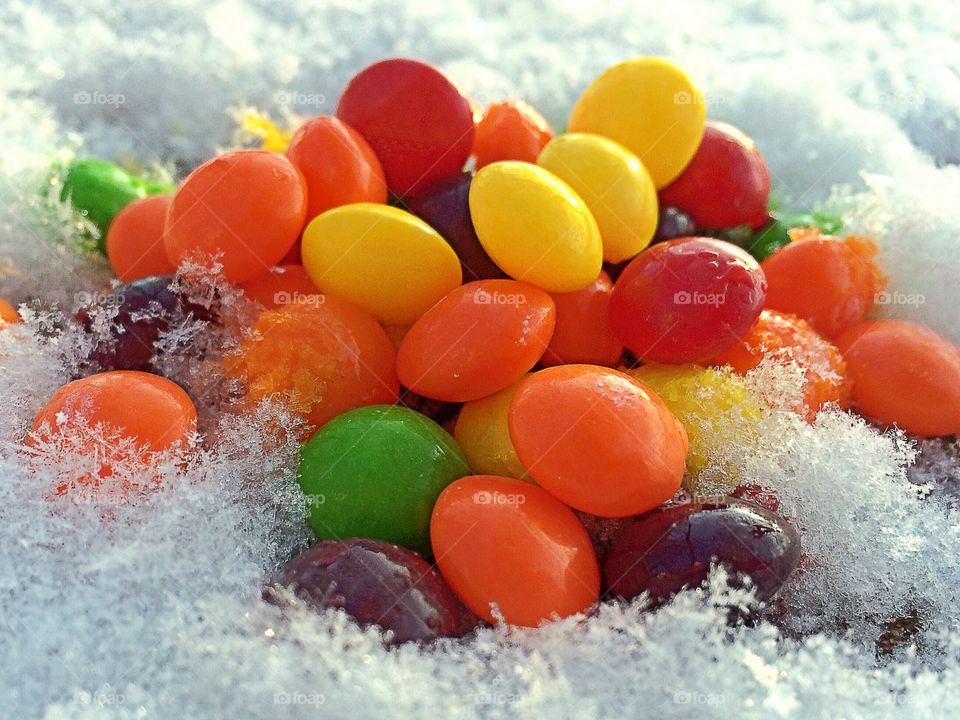 Colorful candies on snow