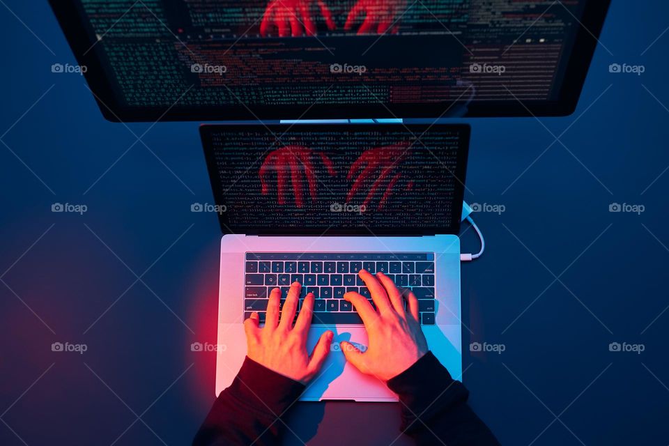 Man using computer and programming  to break code. Cyber security threat. Internet and network security. Stealing private information. Person using technology to steal password and private data. Cyber attack crime