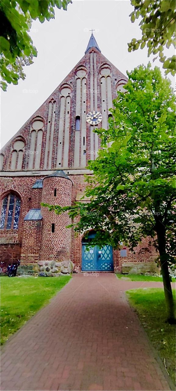This is a medieval brownstone church construction of which started in about 1400. Offset levels permeate the design of this landmark building: “St George” church in “Wiek”, “Mecklenburg - Western Pomerania”, Germany. 2024. Hypnotic Productions