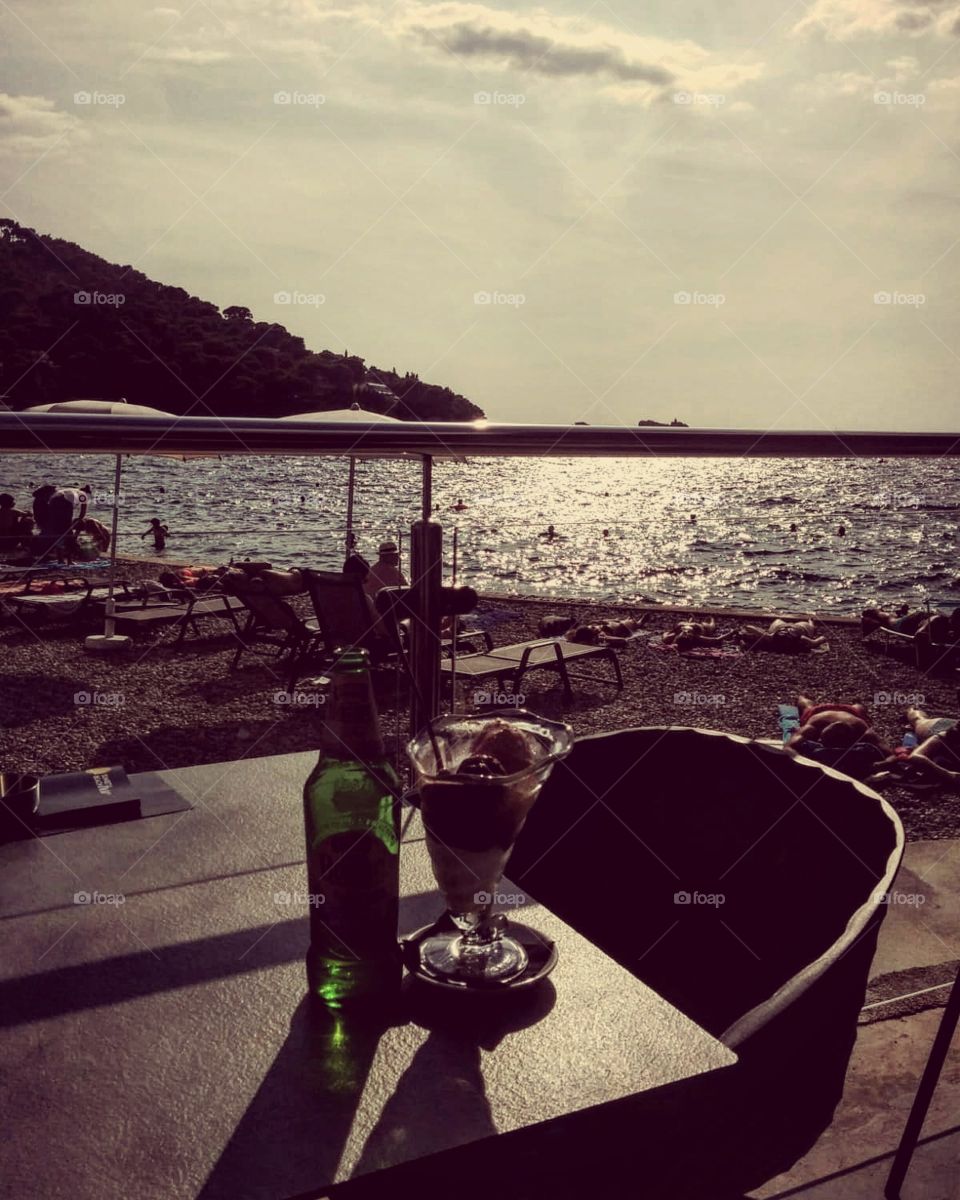 Beer and ice cream by the beach. Relaxing while watching the sun set in the horizon