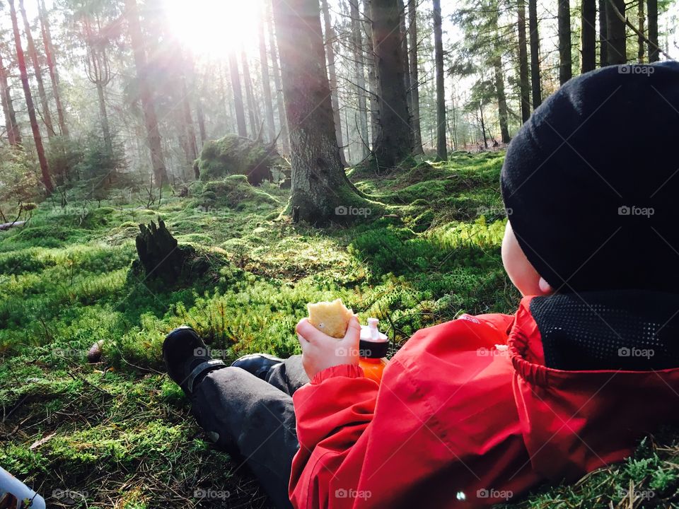 Little boy relaxing in the Forest 