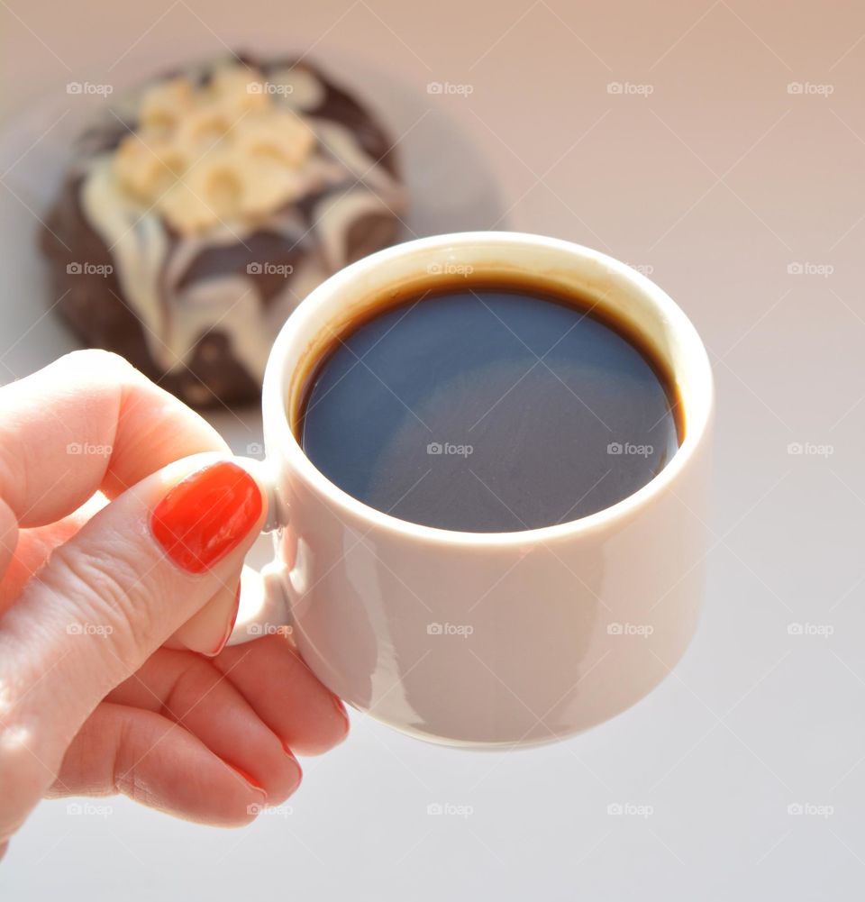 cup of coffee in the female hand close up