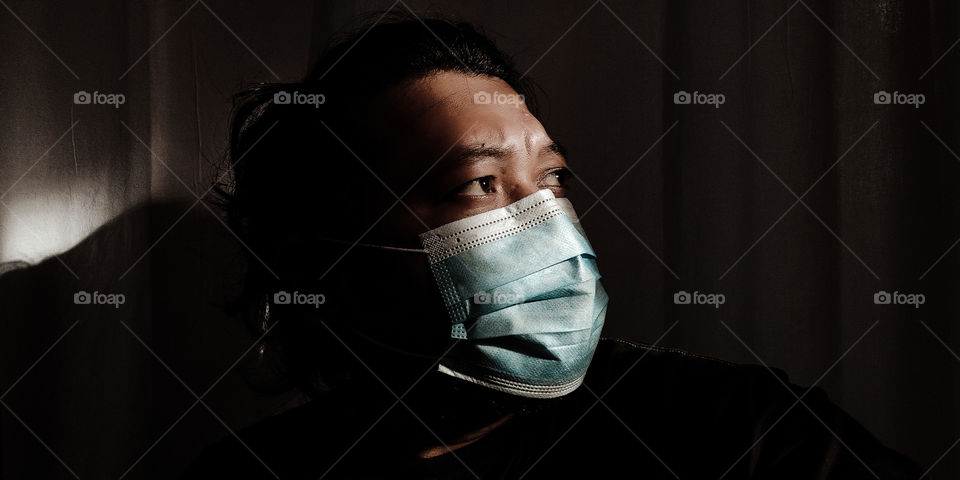 masked man taking a light shower