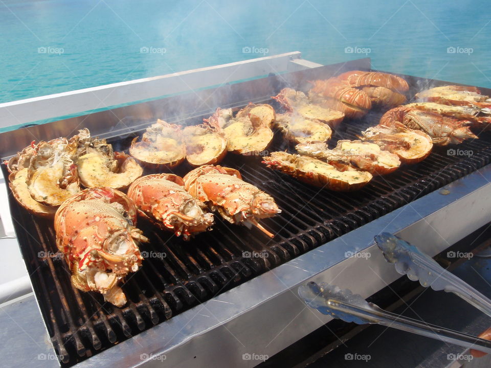 Grilling lobster on a boat