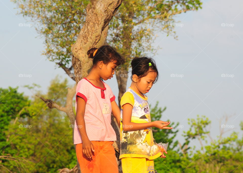 Friendship comparation of two indo-nesia female skin. Good times of two in spend the afternoon for walking on the beach. They'he share story anything, and just playing for the sand near the beach until the times shown for night  and backhome together