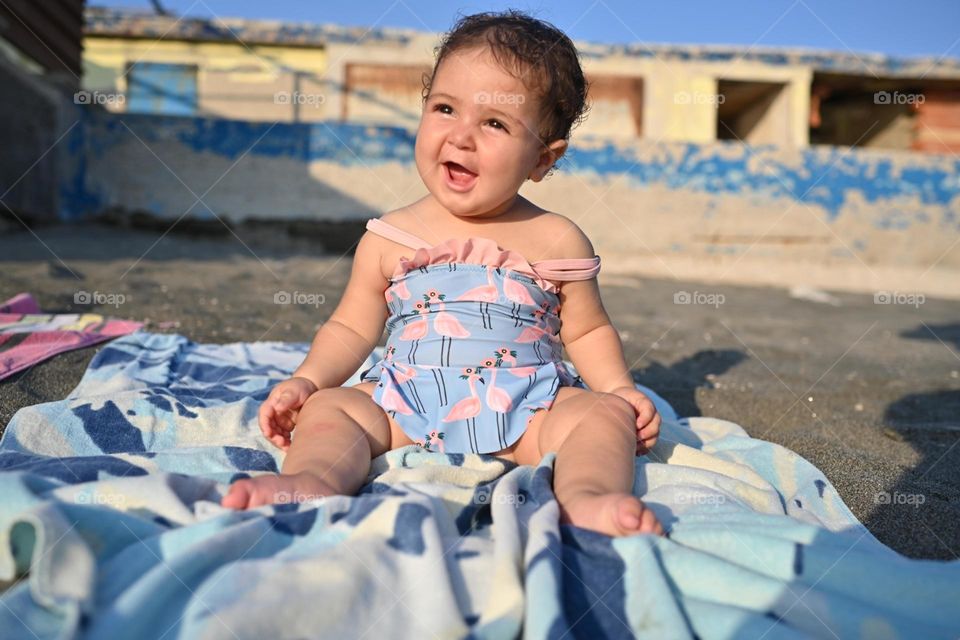 little girl on the beach at sunset