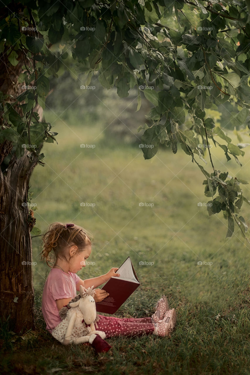 Girl reading the book outdoor