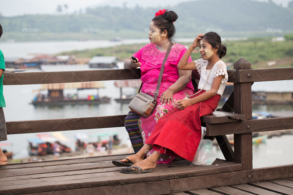 Myanmar girl sitting on the wood bridge in Sagklaburi Kanchanaburi Thailand 