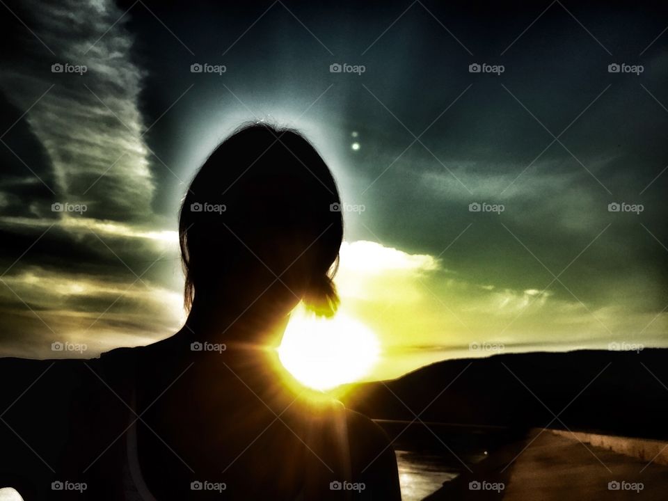 Silhouette of woman at sunset