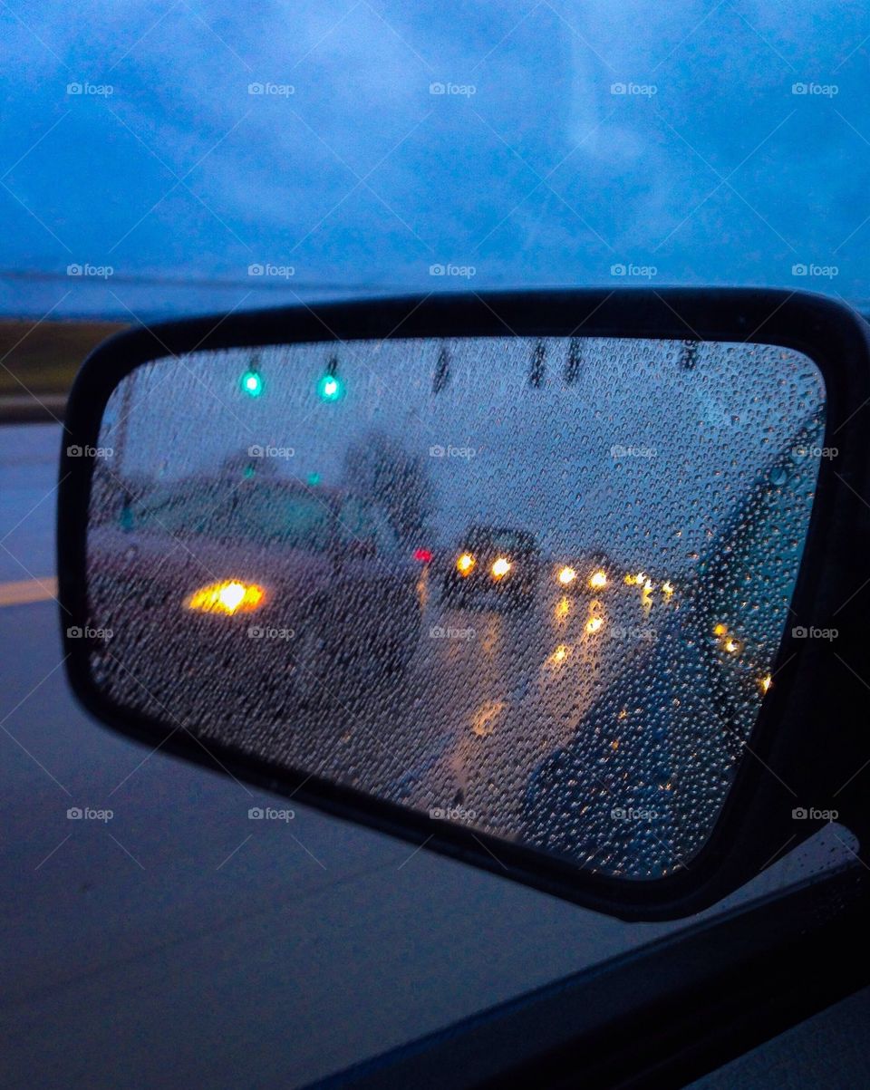 Cars in the mirror in the rain 