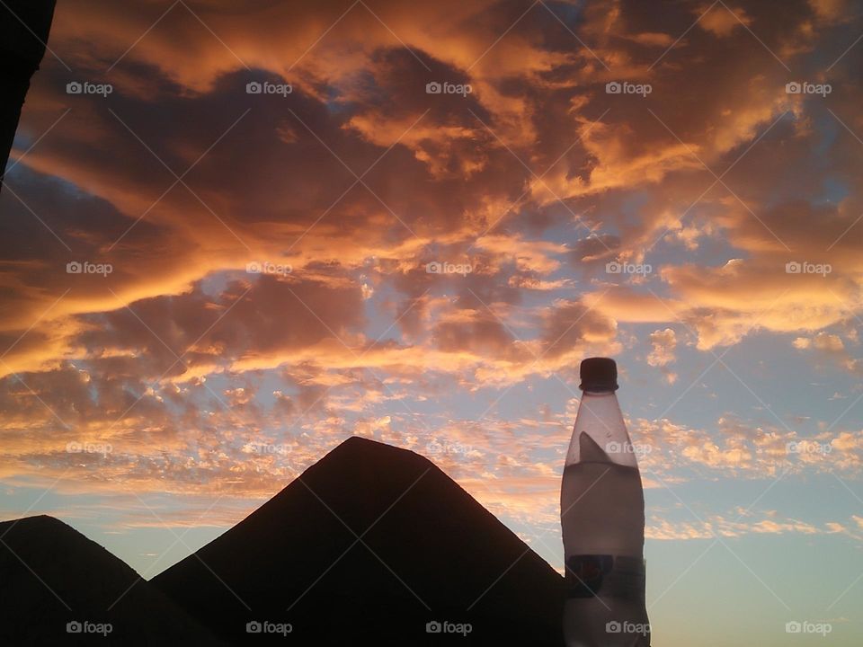 Magic sunset and a beautiful bottle embraces high sky.