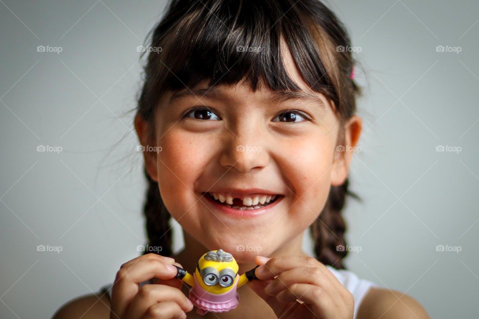 Happy smiling girl with her favourite toy