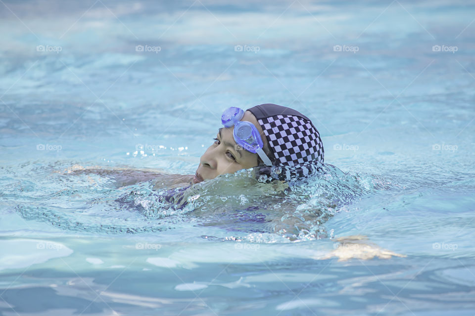 Asian women are swimming in the pool.