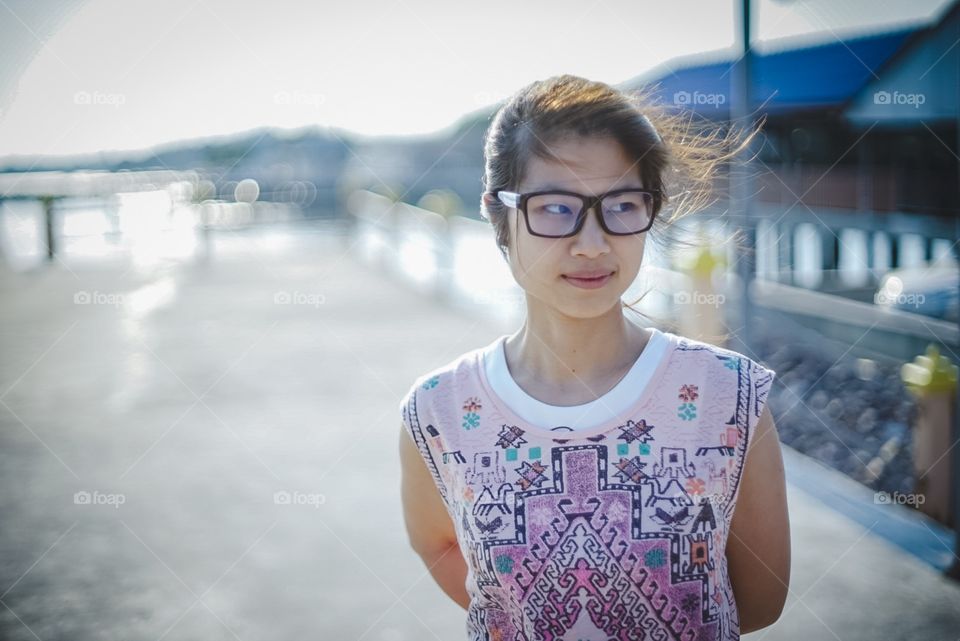 Asian girl with glasses on the beach