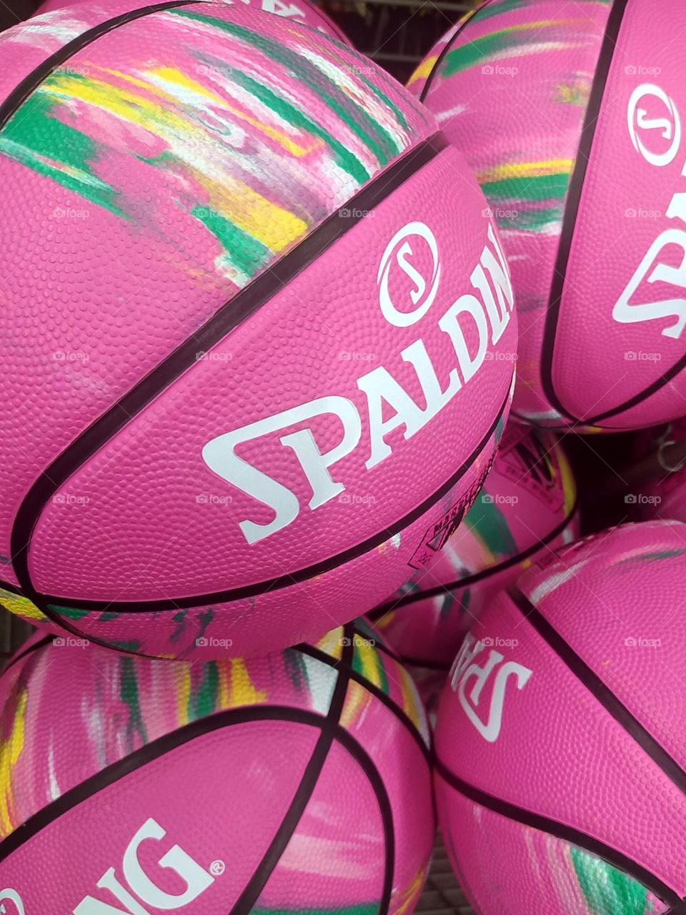 Basketballs in the colors of the Barbie universe on sale in a sports store