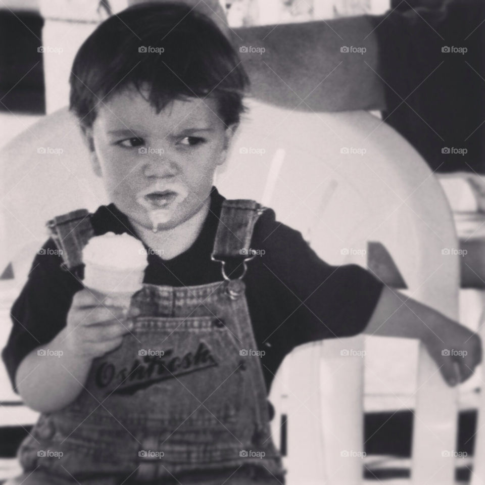 An ice cream goatee on a young boy.