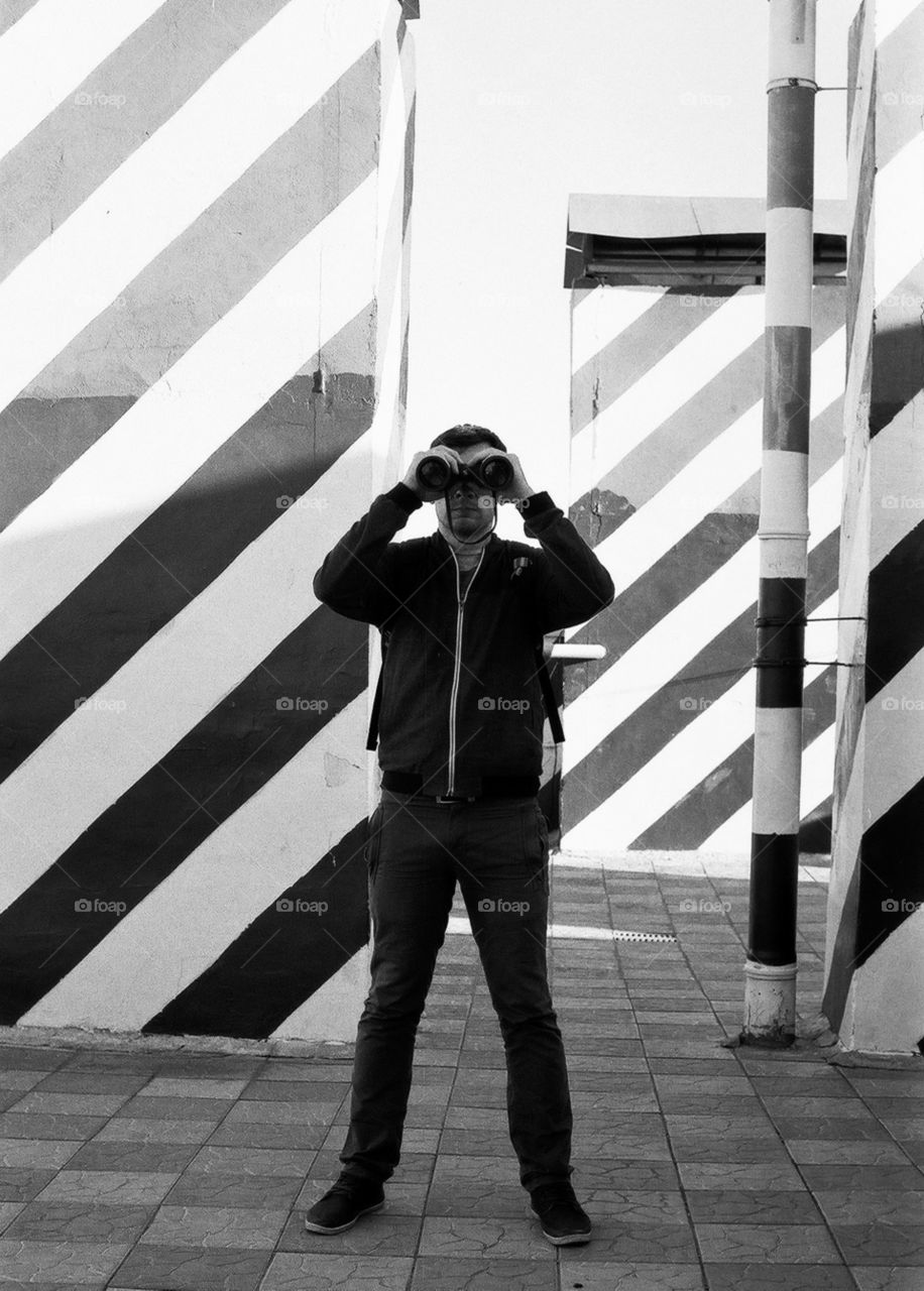 Men with binoculars. Black and white filmphoto