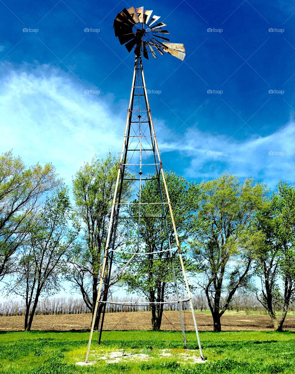 Lonely old windmill sitting on a grassy hill in Filley, Nebraska at the historic Stone House! 