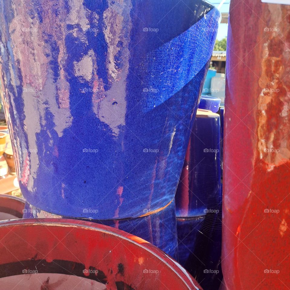 painted ceramic blue and red flowerpots stacked