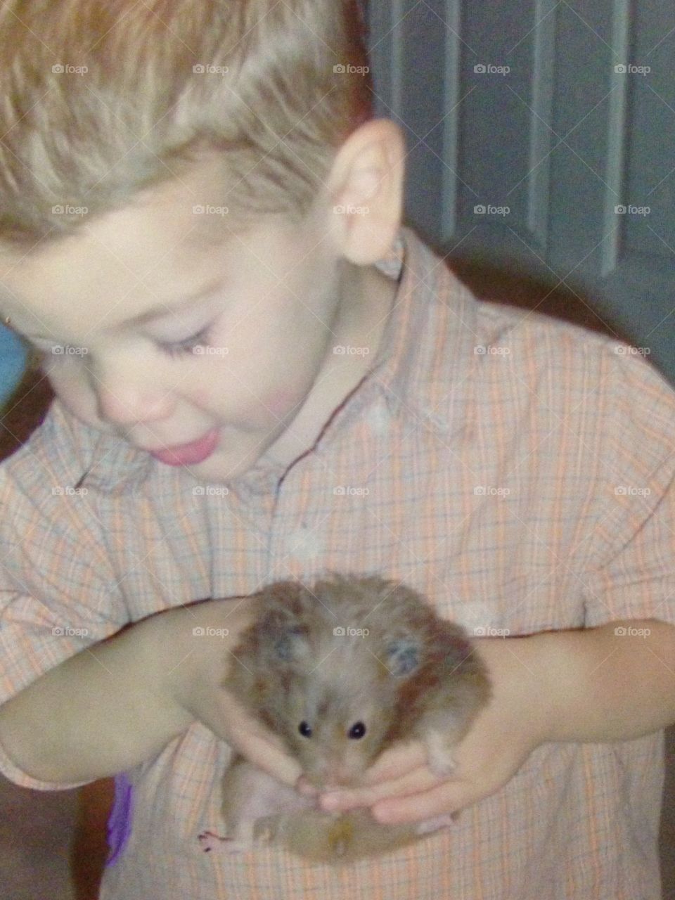 Boy with pet hamster