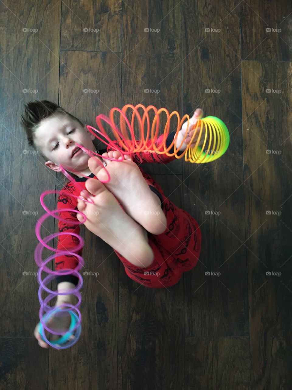 Boy playing with slinky