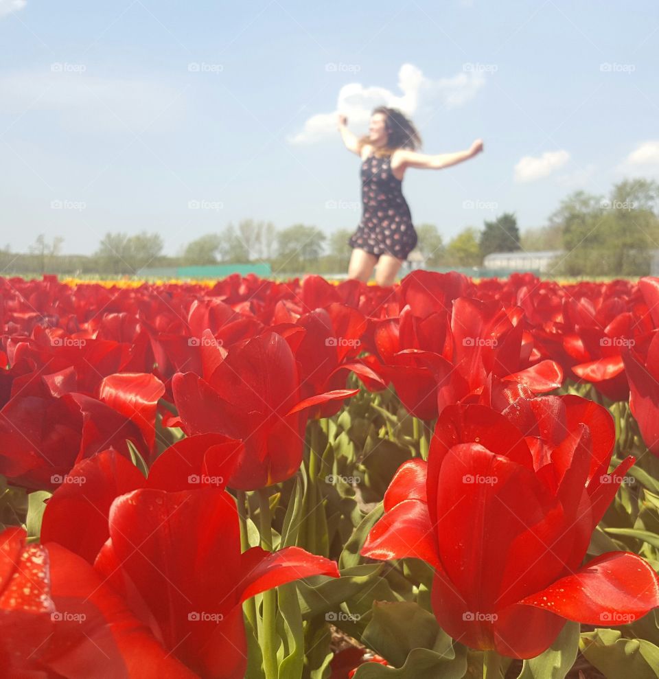 Happy girl in tulip fields