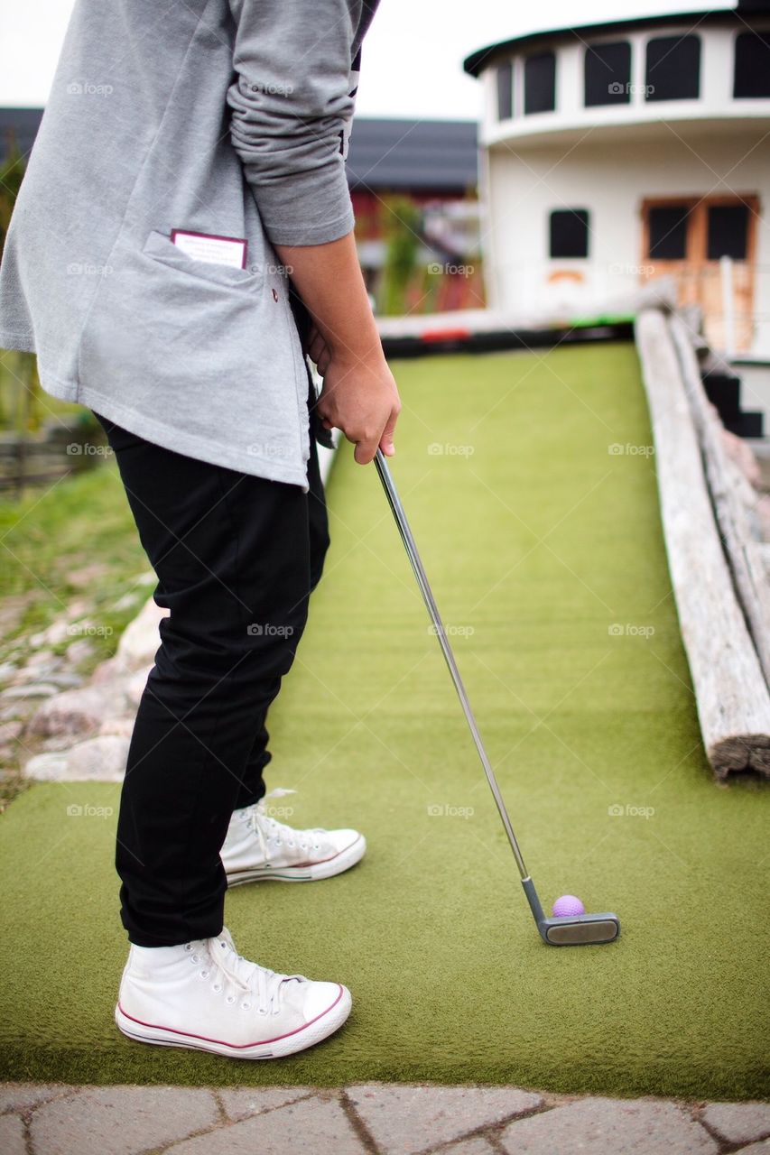 Man playing minigolf