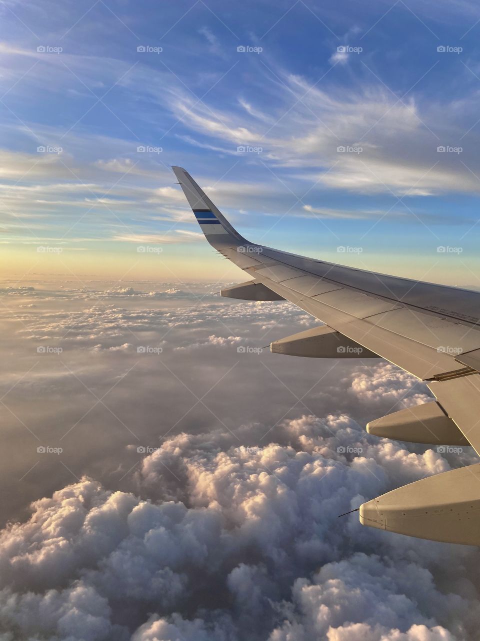 Sunset hues from above.. flying high.. above the clouds
