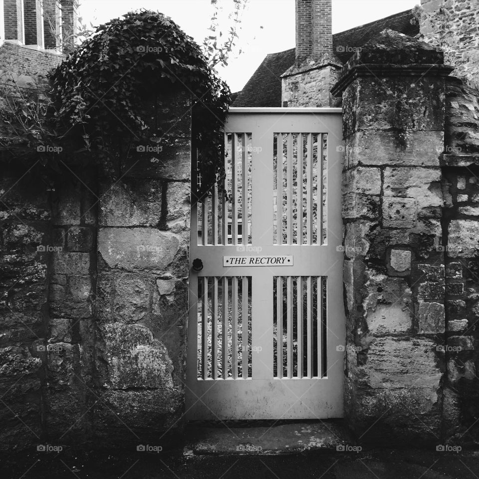 Black and white Old Door way between stone walls 