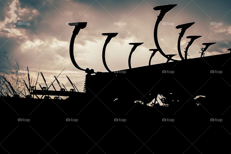 Silhouette Of Abandoned Farm Equipment In Missouri