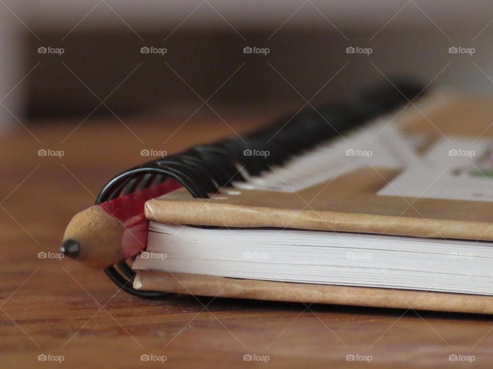 Notebook and pencil in a desk