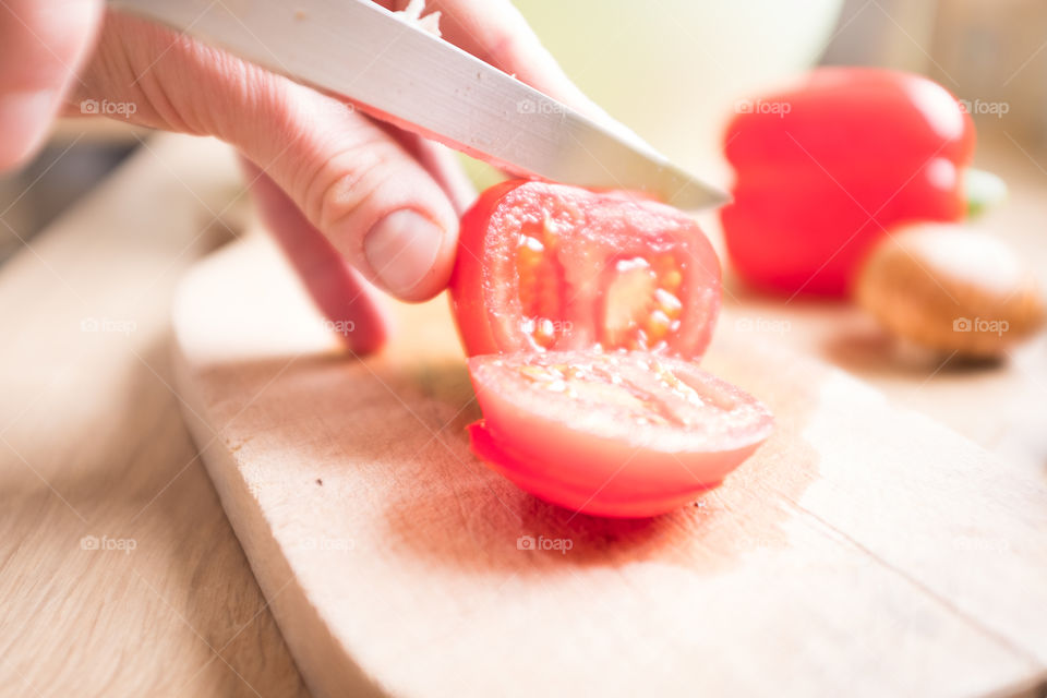 cutting tomatoes in the kitchen 