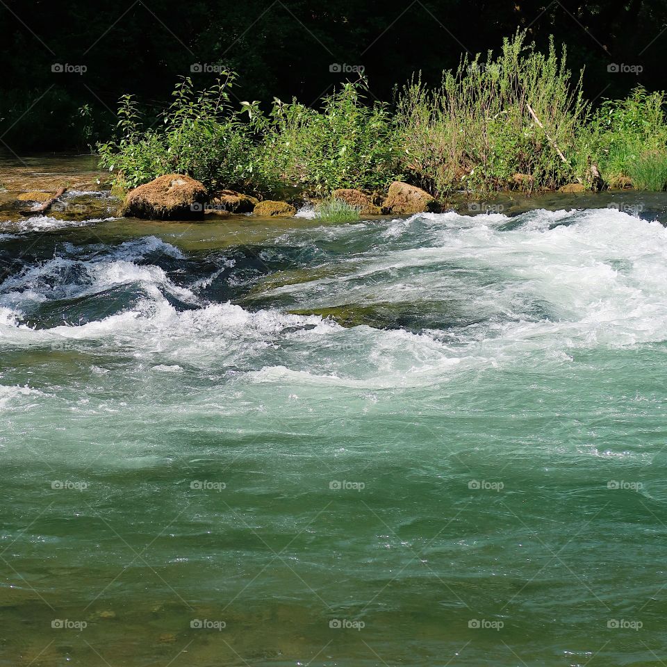 The incredible turquoise waters of the Blue River in the Willamette National Forest on a sunny spring day. 