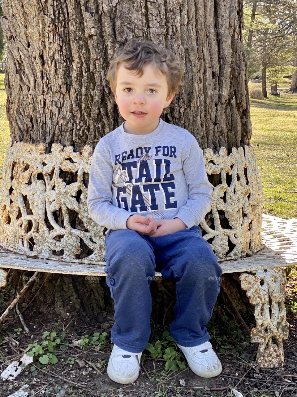 Boy on bench under tree